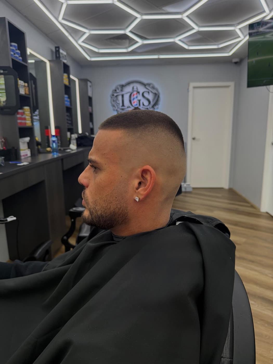 Finished high skin fade with a sharp line-up and trimmed beard