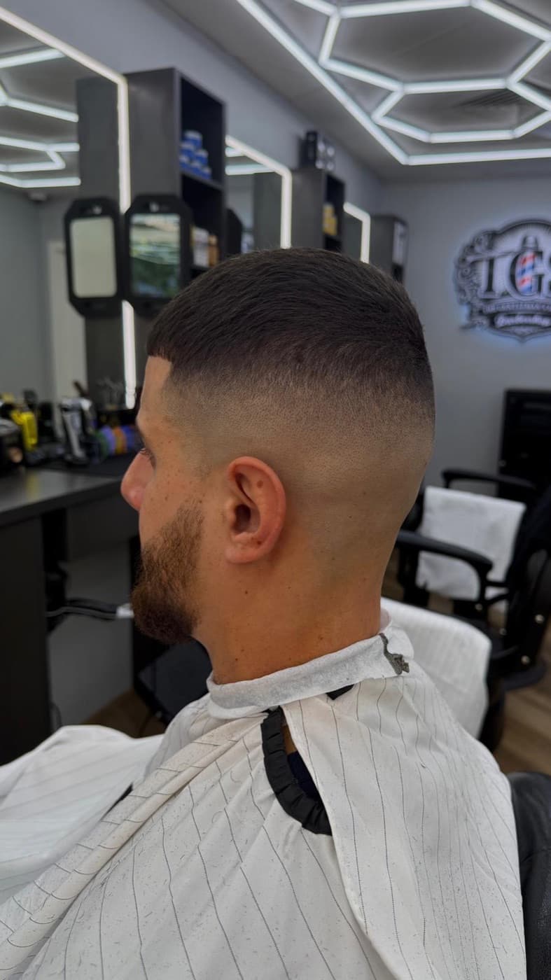 Low fade from behind, blended into a clean neckline